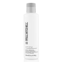 A bottle of Paul Mitchell Soft Style Foaming Pomade. The bottle is white with a grey label and Paul Mitchell branding.